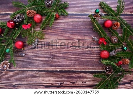 Christmas background with ornaments in dark wooden color. Xmas celebration, greetings, preparation for winter holidays. Festive mockup, top view, flat lay with copy space.