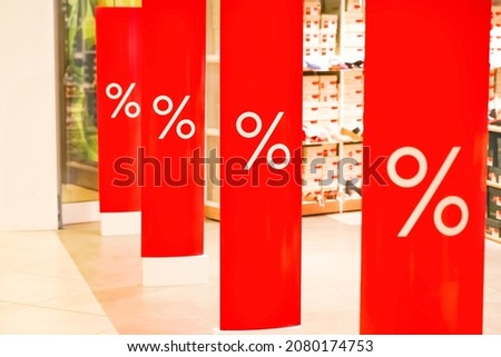 Red poster percent in store on Black Friday. Sale shopping season, promotion discount in shop