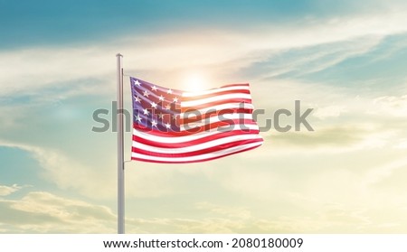 USA national flag waving in beautiful sky.