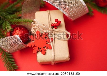 Christmas holidays composition on red background with paper gift box