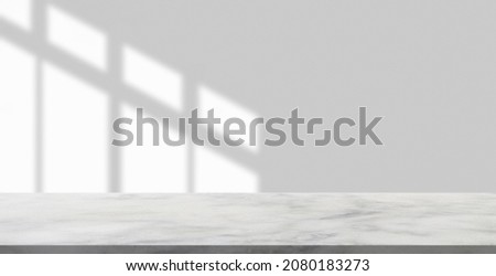 Marble table with window shadow drop on white wall background for mockup product display Royalty-Free Stock Photo #2080183273