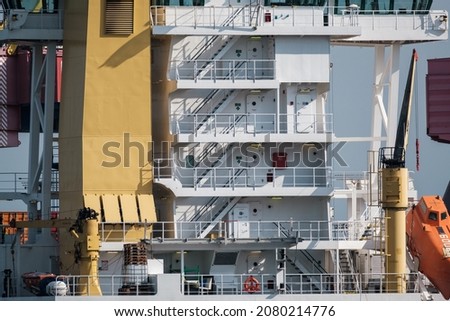 Exterior of contemporary industrial ship with many decks moored in port on sunny day