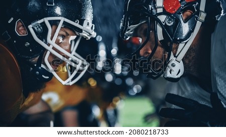 American Football Game Start Teams Ready: Close-up Portrait of Two Professional Players, Aggressive Face-off. Competition Full of Brutal Energy, Power, Skill. Rainy Night with Dramatic Light Royalty-Free Stock Photo #2080218733