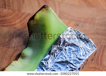 A piece of fresh aloe vera wrapped in aluminum foil to keep it fresh.