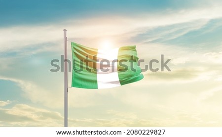 Nigeria national flag waving in beautiful sky.