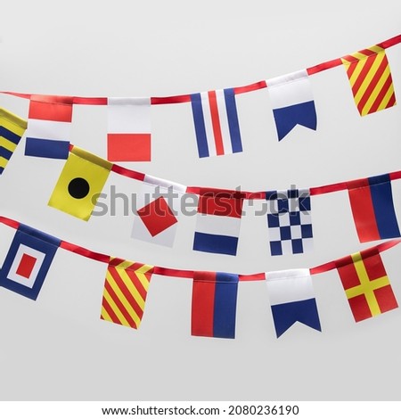 Garland of international maritime signal flags on white background Royalty-Free Stock Photo #2080236190