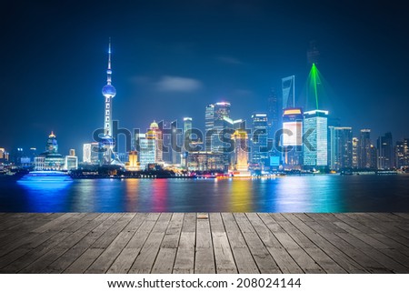 shanghai skyline at night , light show with wooden floor prospect 