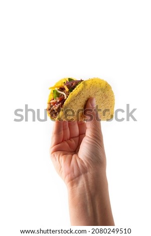 Hand holding traditional Mexican tacos with meat and vegetables isolated on white background Royalty-Free Stock Photo #2080249510