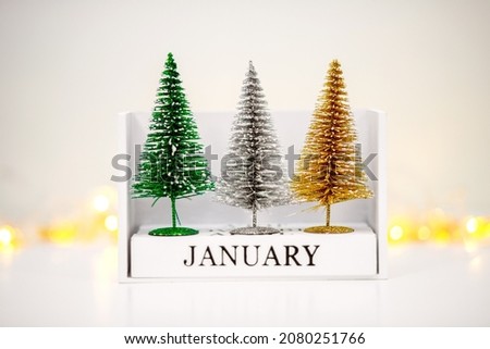 Desk calendar with the date of January 1, the concept of New Year and Christmas, green trees, minimalism in the image, new year background and wallpaper.
