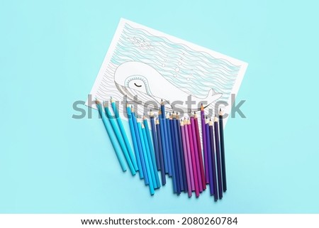 Coloring picture and pencils on color background