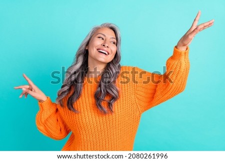 Photo of senior excited lady good mood enjoy event wondered look empty space isolated over turquoise color background