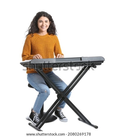 Young woman playing synthesizer on white background Royalty-Free Stock Photo #2080269178