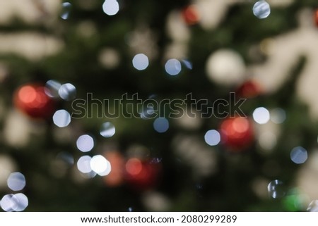 Blurred picture of christmas tree with lights. Abstract blur glitter bokeh.