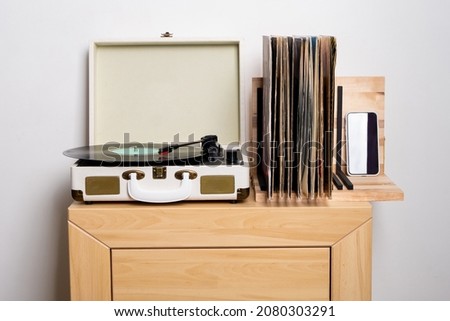 Close up of turntable and shelf with vinyl records Royalty-Free Stock Photo #2080303291
