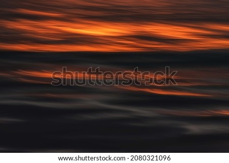 Long ever lasting sunsets shine on the surface of the Atlantic ocean, with glamour on the surface of the cold water of the Artic Circle