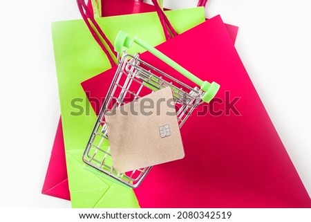 Christmas sale black friday background with shopping red green paper bags, shopping cart, smartphone, bank card on white background copy space