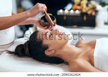 Shot of beautiful young woman having reiki healing treatment in health spa center Royalty-Free Stock Photo #2080362604
