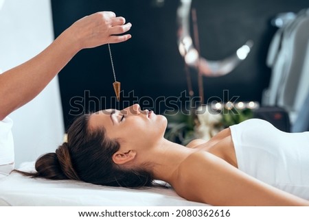 Shot of beautiful young woman having reiki healing treatment in health spa center Royalty-Free Stock Photo #2080362616