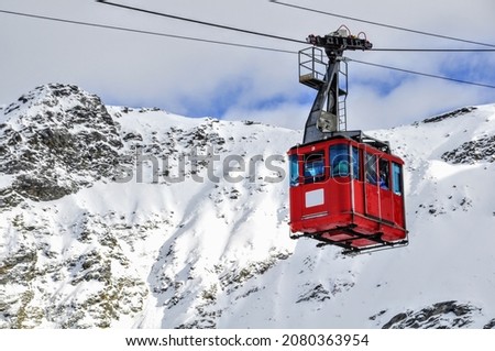 Madesimo cableway, ski resort in the Alps, colorful, snow and mountains Royalty-Free Stock Photo #2080363954