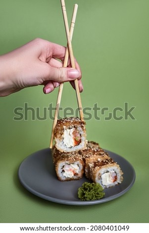 Japanese cuisine sushi on a plain light green background
