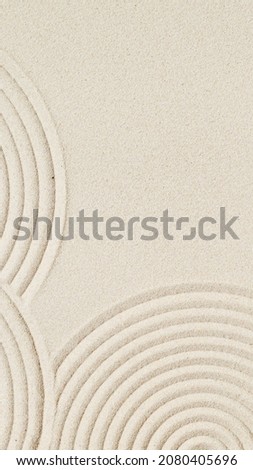 Lines drawing on sand, beautiful sandy texture. Spa background, minimal concept for meditation and relaxation. Vertical format for stories.