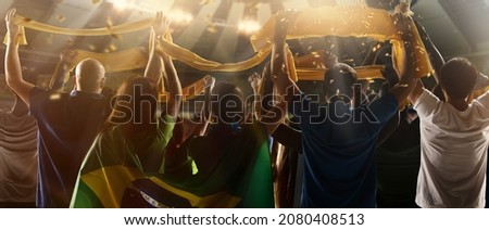 At world cup. Back view of football, soccer fans from Brazil cheering their team with green yellow state flags and scarfs at crowded stadium. Concept of sport, support, team event, competition and Royalty-Free Stock Photo #2080408513