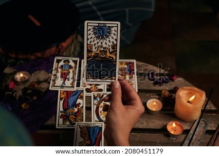 Close-up of a fortune teller reading tarot cards Royalty-Free Stock Photo #2080451179