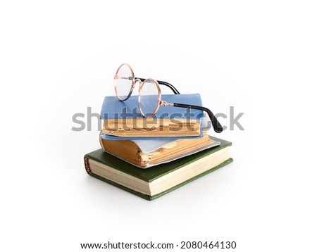 Stack of books and glasses. Studio photo on a white background.
