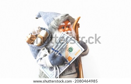 Santa Claus with dollars banknotes on white background. Christmas greeting card or Festive decor. Creative copy space. Close-up