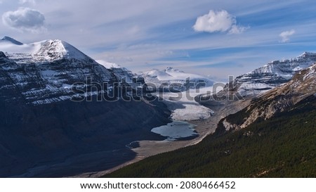 Stunning view of majestic Saskatchewan Glacier, part of Columbia Icefield, in Banff National Park, Alberta, Canada in the Rocky Mountains in valley with glacial lagoon on cloudy day in autumn. Royalty-Free Stock Photo #2080466452