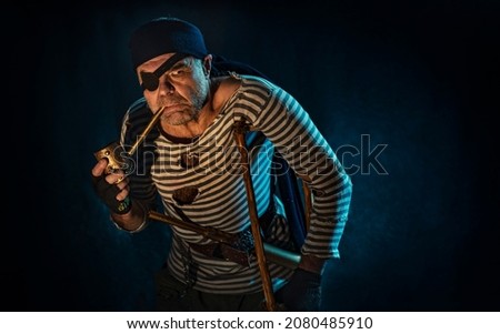 
Injured man dressed as a pirate with a smoking pipe with a crutch