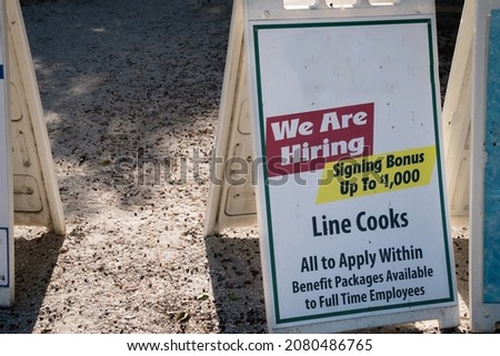 Sign at local restaurant during the time of Covid-19 looking to hire staff with a large hiring bonus.