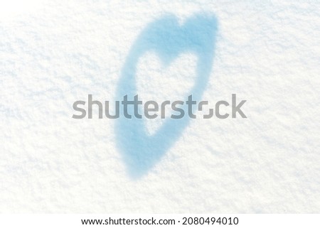 Heart on white snow. Place for an inscription. The basis for the postcard