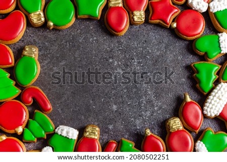 frame from Christmas gingerbread green red color on a dark background copy space in the center of the photo