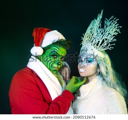 couple young, green santa christmas ice fairy man and woman with two christmas costume celebrating christmas