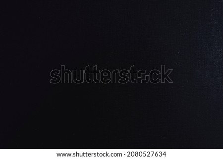 Black background of thick plastic sheet of book cover. Jet black textured pattern backdrop