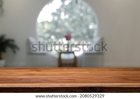 Empty wooden desk with blur background of cafe and bistro. For montage product.