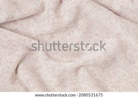 Knitted woolen or cashmere texture background. Warm sweater, pullover pattern closeup Royalty-Free Stock Photo #2080531675