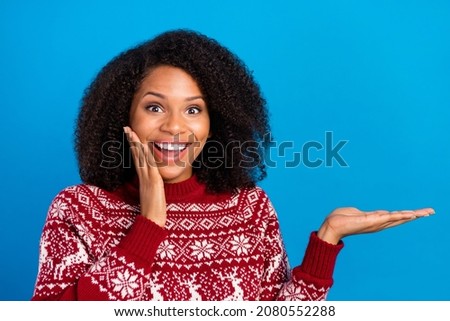 Photo of pretty impressed woman dressed print sweater arm cheek holding arm empty space isolated blue color background