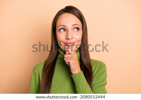 Photo of young pretty lady hand face wondering look ad wear green pullover isolated on beige color background