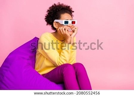 Photo of afraid young brunette lady watch movie wear shirt jeans eywear isolated on pink background