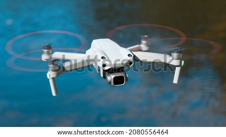 Drone. Professional drone with 5K camera for take a video, photo, film, movie footage. Aerial photography.  copter flying over water. Flight technology. Wireless controlled drone.
