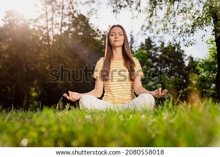 Full length body size photo woman sitting on grass practising yoga excercises in summer park Royalty-Free Stock Photo #2080558018