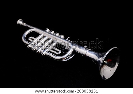 Silver Vintage Toy Trumpet on a Black Background