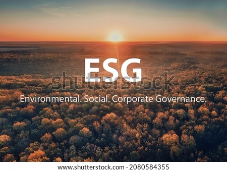 ESG Sustainable environmental conservation concept. Sunrise over the autumn forest on foggy morning. Sustainable ESG Technology of renewable resources to reduce pollution and carbon emission of Nature Royalty-Free Stock Photo #2080584355