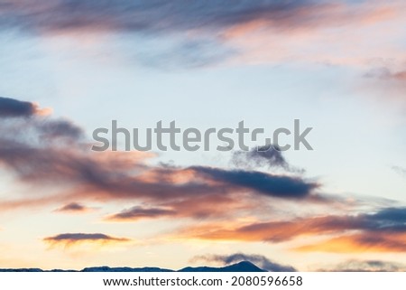 Dark clouds with hints of pink, purple and orange tones great for editing or sky replacement filters photography resources. 