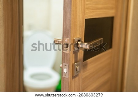 The toilet door is open, a white toilet is visible.