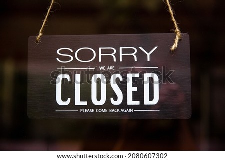 Sorry we are closed sign hanging on the front door when covid-19, coronavirus, closed signage symbol for the coffee shop is close.