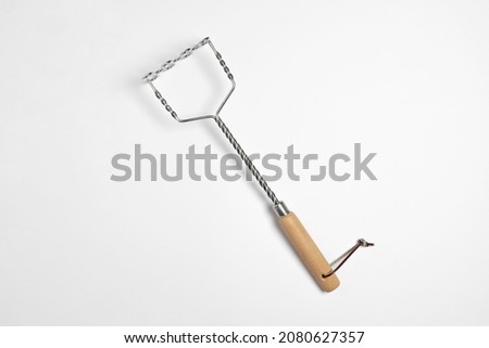 Stainless steel Potato masher with 
wooden handle isolated on white background.Potato pestle. High resolution photo. Royalty-Free Stock Photo #2080627357