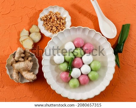 Top View Colorful Chinese Food Hot Soup Dessert, Glutinous Rice Ball Soup "Tangyuan" Orange Table. Royalty-Free Stock Photo #2080657315